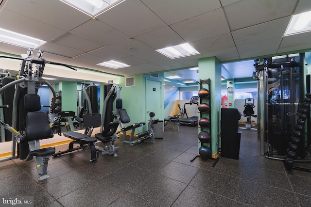 exercise room featuring a drop ceiling