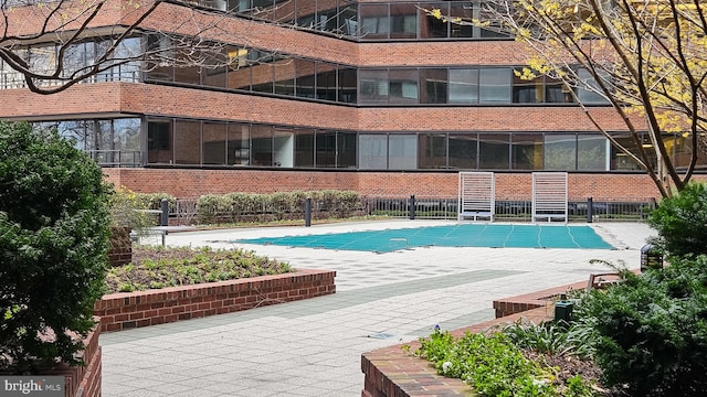 pool featuring a patio and fence