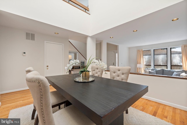 dining room featuring visible vents, baseboards, and light wood-style floors