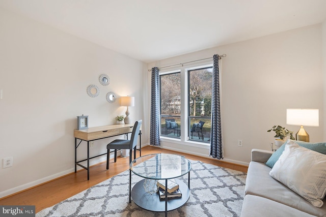 office featuring baseboards and wood finished floors