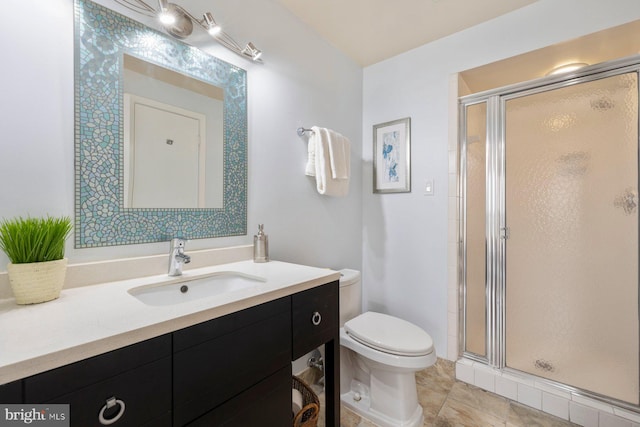 bathroom with toilet, a stall shower, vanity, and tile patterned flooring