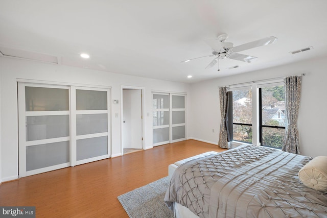 bedroom with visible vents, recessed lighting, baseboards, and wood finished floors