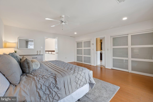 bedroom featuring recessed lighting, baseboards, wood finished floors, and a ceiling fan