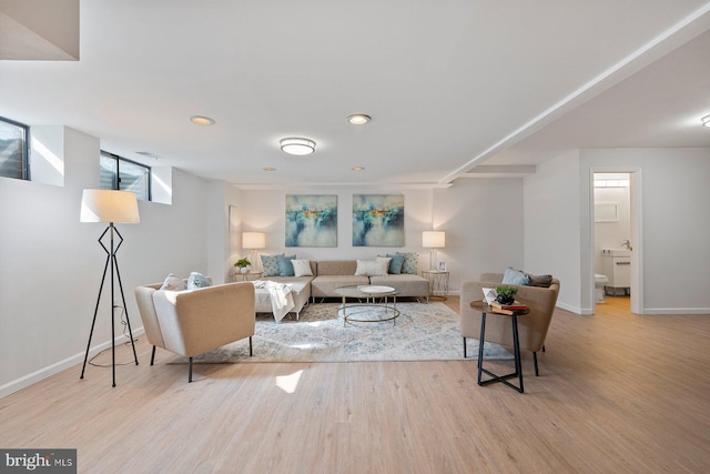 living area featuring recessed lighting, baseboards, and wood finished floors