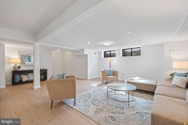 living room with recessed lighting, baseboards, light wood-style flooring, and a fireplace