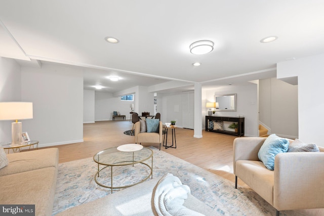 living room with stairs, recessed lighting, and wood finished floors