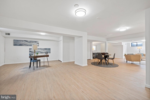 interior space featuring visible vents, baseboards, and light wood finished floors