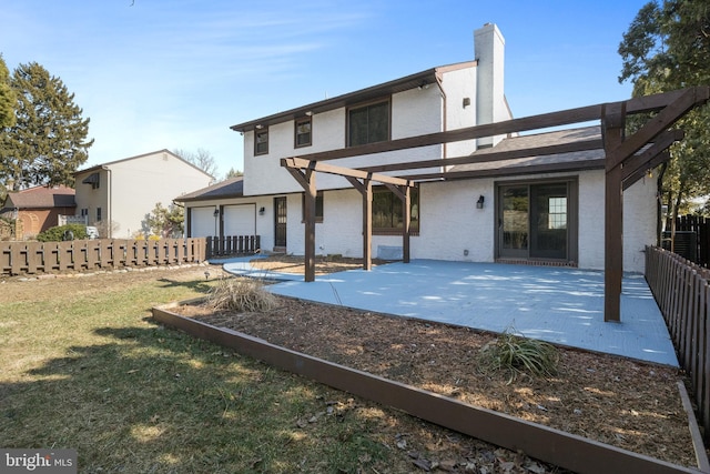 back of house with a yard, a patio area, fence, and a pergola