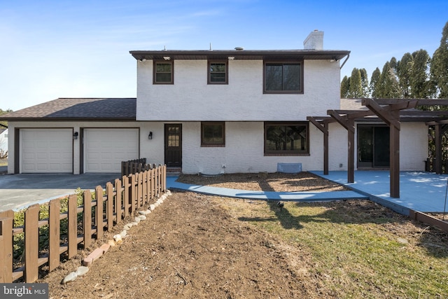 view of front of house featuring a garage, a shingled roof, driveway, a pergola, and a chimney