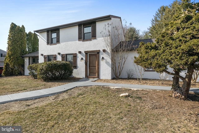 view of front of home with a front lawn and stucco siding