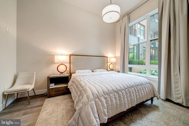 bedroom featuring baseboards and wood finished floors