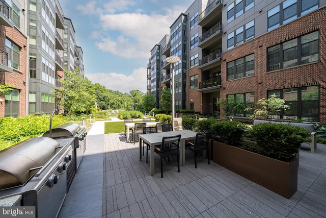 exterior space featuring exterior kitchen and outdoor dining area