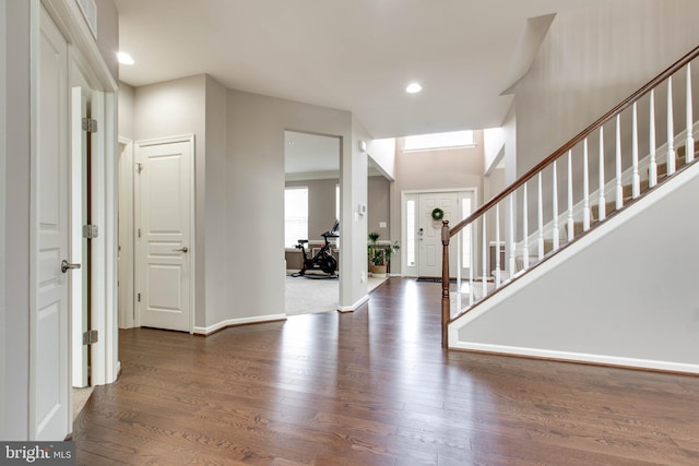 entryway with recessed lighting, stairway, baseboards, and wood finished floors