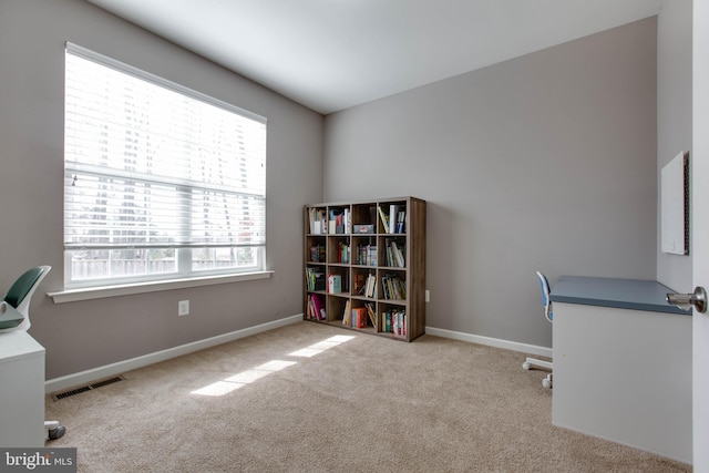 office space with carpet floors, visible vents, and baseboards