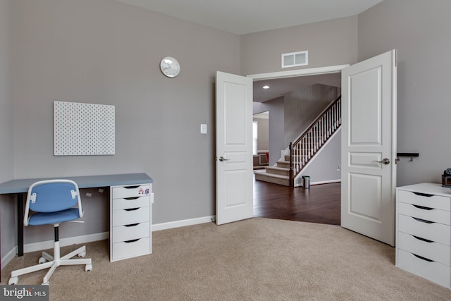 carpeted home office with baseboards and visible vents