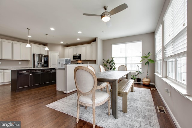 dining space featuring dark wood-type flooring, recessed lighting, visible vents, and baseboards