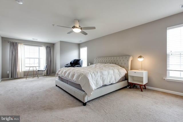 bedroom with multiple windows, carpet, and baseboards