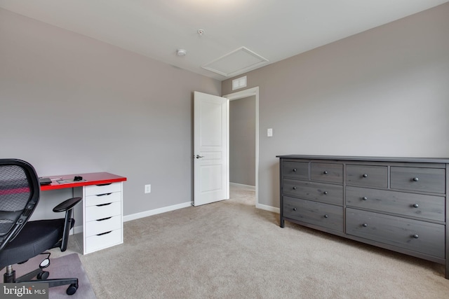 home office featuring light carpet, attic access, and baseboards