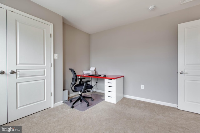 carpeted home office with baseboards