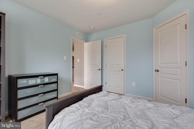 bedroom with visible vents and baseboards