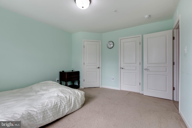 carpeted bedroom featuring baseboards