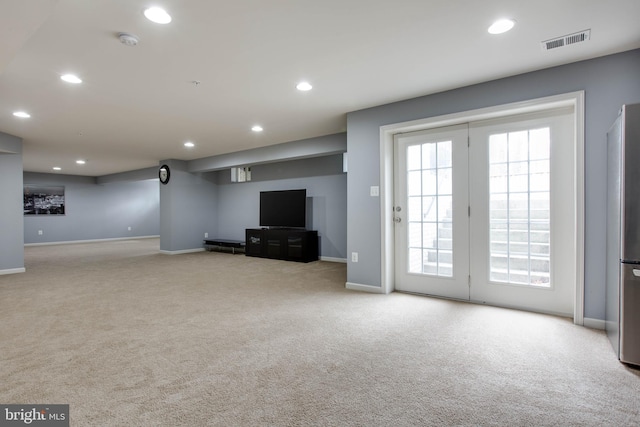 unfurnished living room with carpet floors, visible vents, and recessed lighting