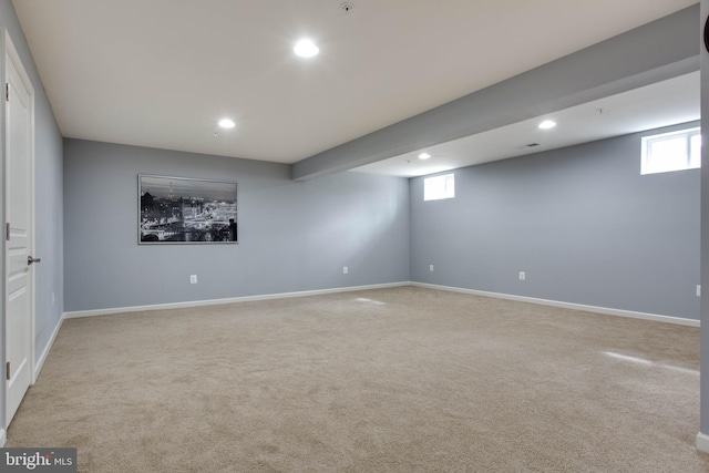 spare room featuring light carpet, baseboards, and recessed lighting