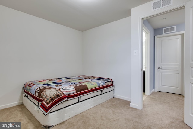 bedroom featuring carpet floors, visible vents, and baseboards