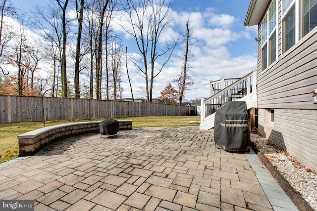 view of patio / terrace with stairs, grilling area, and a fenced backyard