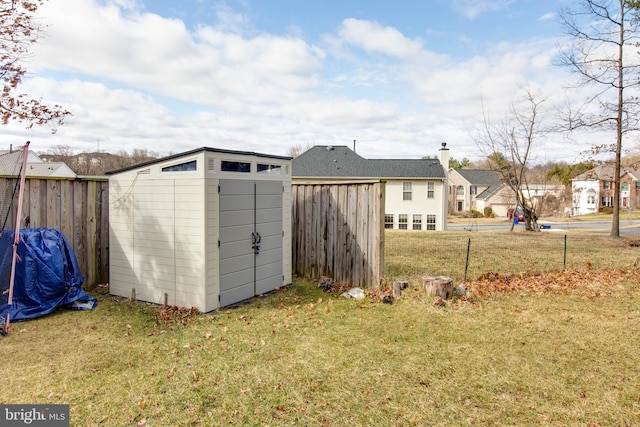 view of shed featuring a residential view and fence