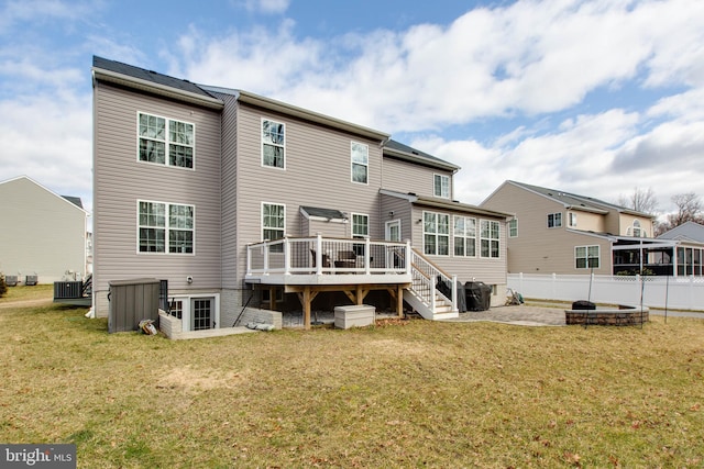 back of property featuring central air condition unit, fence, a lawn, and a wooden deck