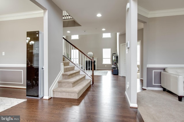 foyer featuring baseboards, dark wood finished floors, stairway, crown molding, and recessed lighting