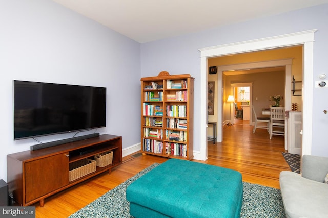 living room with baseboards and light wood-style flooring