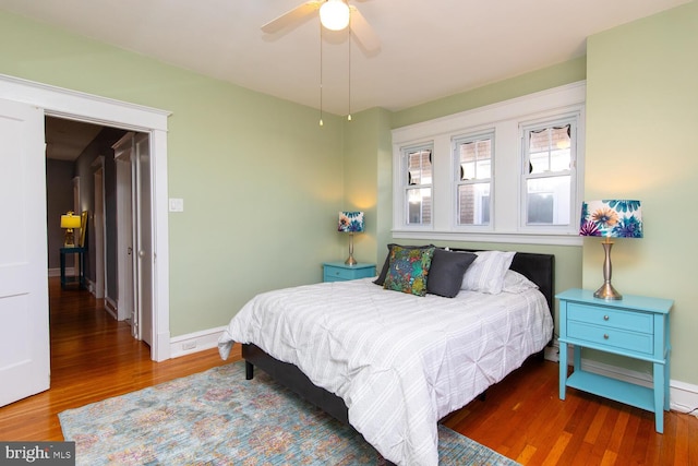 bedroom with wood finished floors, baseboards, and ceiling fan