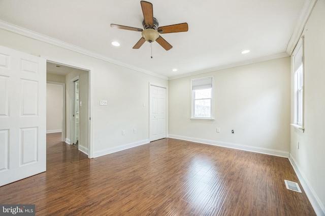 spare room with recessed lighting, wood finished floors, visible vents, baseboards, and crown molding