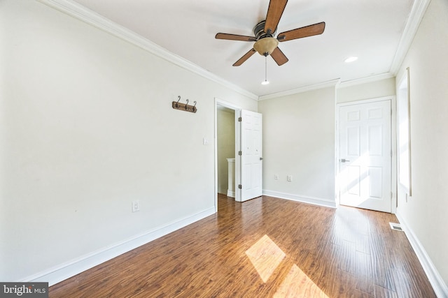 unfurnished bedroom with visible vents, baseboards, a ceiling fan, wood finished floors, and crown molding