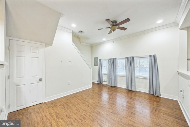 unfurnished room with baseboards, visible vents, ceiling fan, wood finished floors, and crown molding