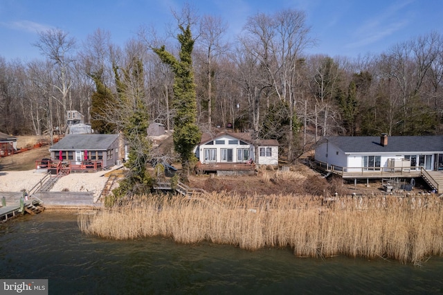 rear view of property with a deck with water view