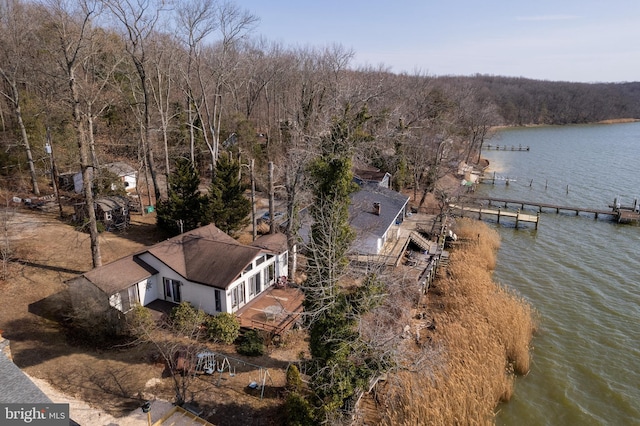 birds eye view of property featuring a water view and a forest view