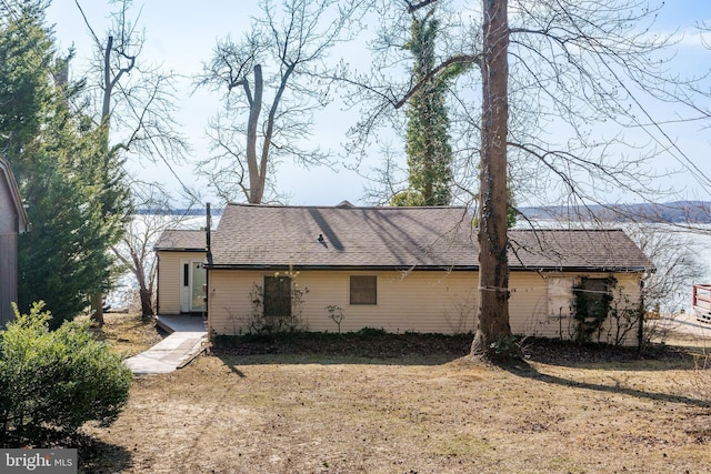 back of property with a shingled roof