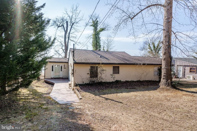 back of property featuring a shingled roof