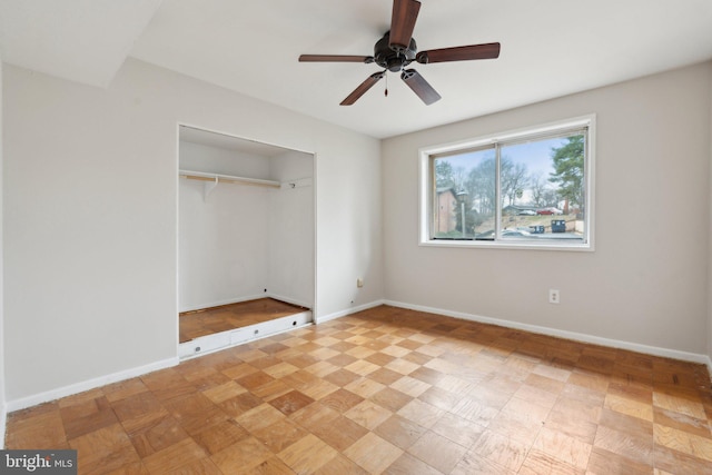 unfurnished bedroom featuring a closet, ceiling fan, and baseboards