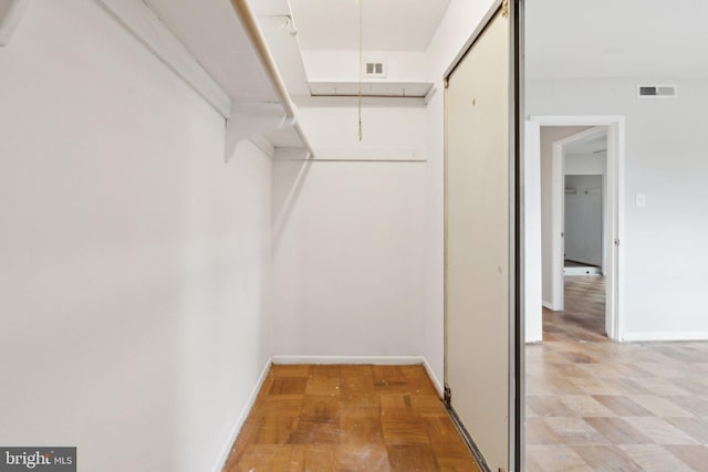 walk in closet featuring visible vents and attic access