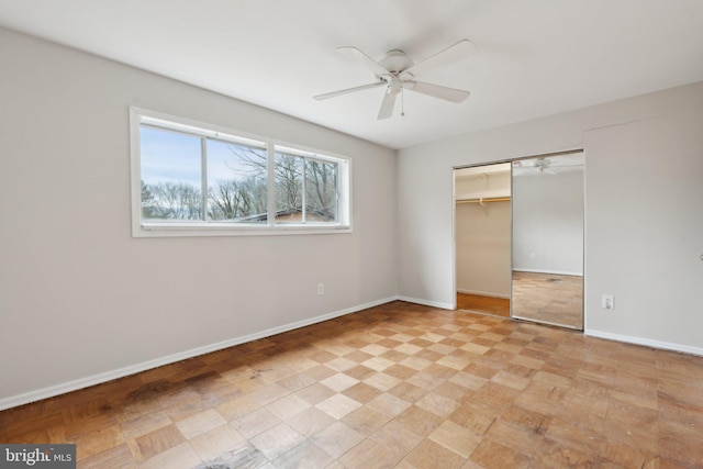 unfurnished bedroom with a ceiling fan, a closet, and baseboards