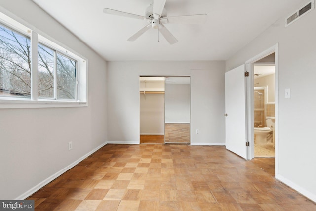 unfurnished bedroom with baseboards, visible vents, ceiling fan, and a closet