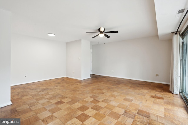 unfurnished room with visible vents, ceiling fan, and baseboards