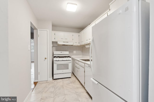 kitchen with marble finish floor, light countertops, white cabinetry, white appliances, and under cabinet range hood