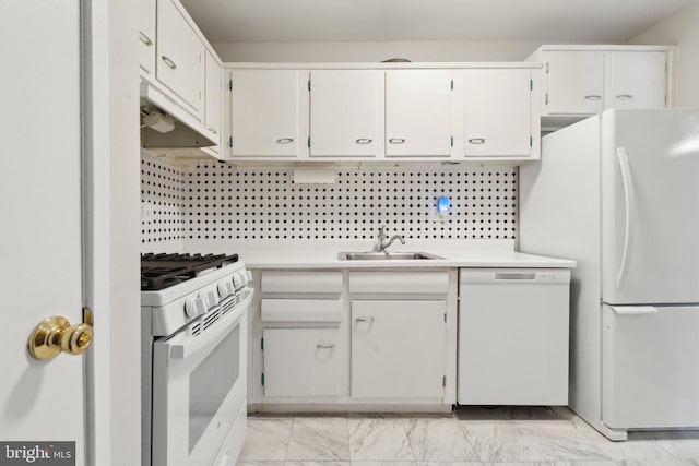 kitchen featuring white appliances, marble finish floor, light countertops, under cabinet range hood, and a sink