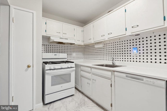 kitchen featuring under cabinet range hood, white appliances, a sink, marble finish floor, and light countertops