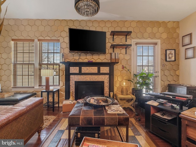 living area featuring wood finished floors and a glass covered fireplace